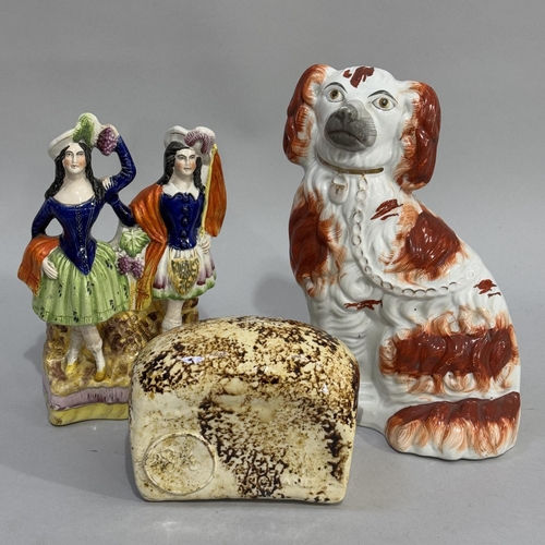 68 - A mid-Victorian Staffordshire pottery flat back group of Scotsman and lass, well modelled, polychrom... 