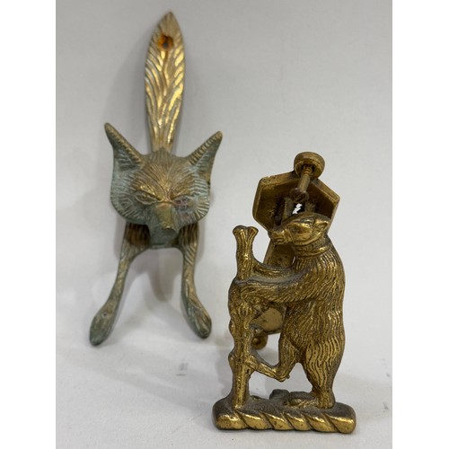 55B - Two brass door knockers, one in the form of a bear and the other as a fox mask