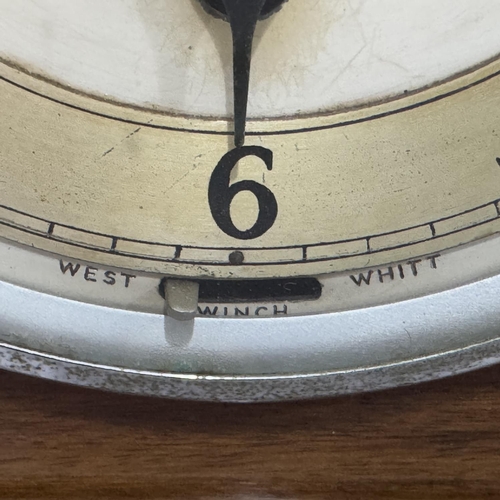 257 - An Art Deco walnut and ebonised mantel clock of domed profile having black numerals to the chapter r... 