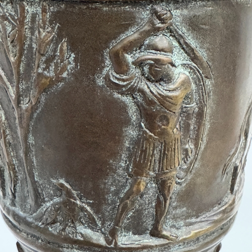 305 - A bronze ewer cast with band of figures and horses, huntsmen and warriors below a fluted neck and tw... 