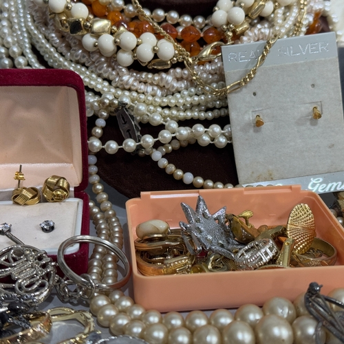 374 - A box of costume jewellery including chains, faux pearls, earrings, necklaces, cufflinks, bracelets,... 