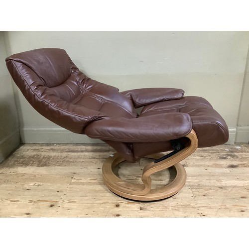 229 - A Himolla  brown leather reclining chair on round swivel base