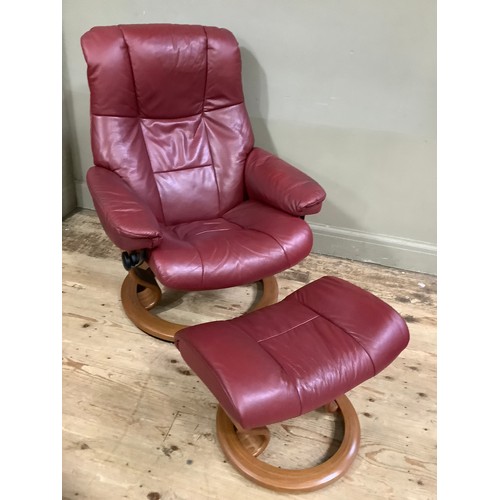 230 - A Stressless reclining chair and matching footstool in burgundy leather