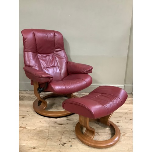 230 - A Stressless reclining chair and matching footstool in burgundy leather