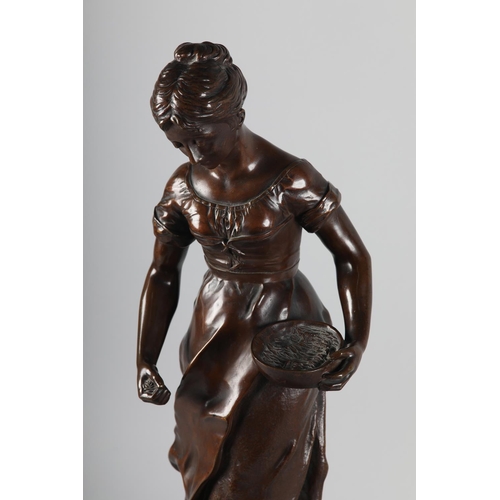 325 - AFTER A ESPIE (French), Bronze figure of a country girl feeding chickens at her feet, on naturalisti... 