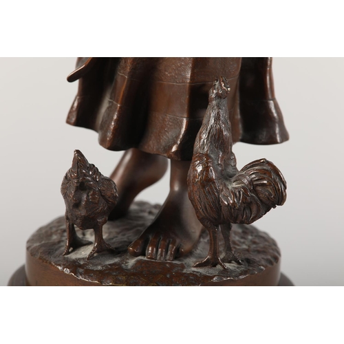 325 - AFTER A ESPIE (French), Bronze figure of a country girl feeding chickens at her feet, on naturalisti... 