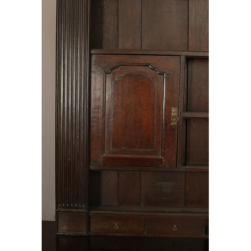 407 - A LARGE GEORGE II STYLE OAK DRESSER AND frieze over a planked back with four shelves, central fluted... 