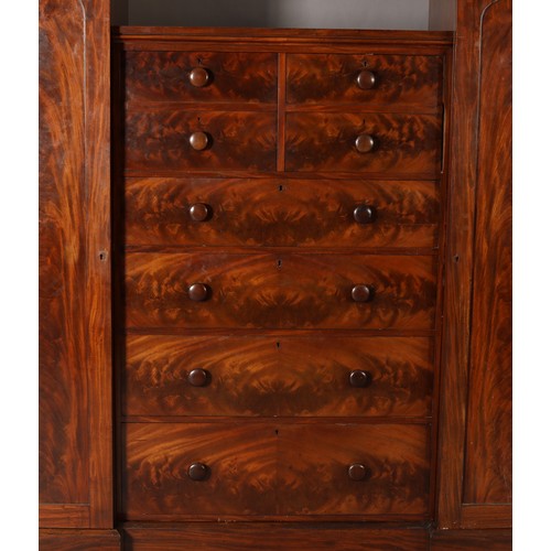 413 - AN EARLY VICTORIAN FIGURED MAHOGANY WARDROBE-CHEST, the centre section having two dummy drawer cupbo... 