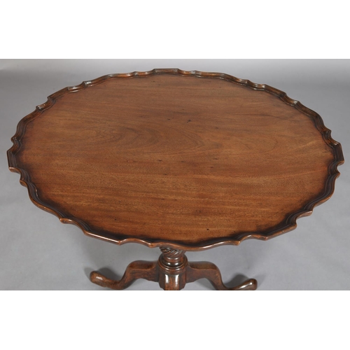 455 - A GEORGE III MAHOGANY TILT TOP TABLE, circular with pie crust rim on a writhern vase turned pedestal... 