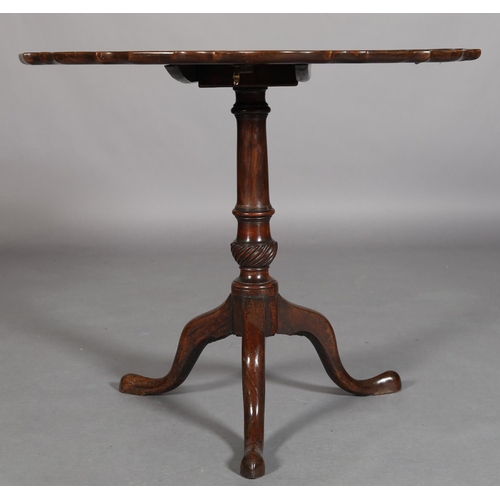 455 - A GEORGE III MAHOGANY TILT TOP TABLE, circular with pie crust rim on a writhern vase turned pedestal... 