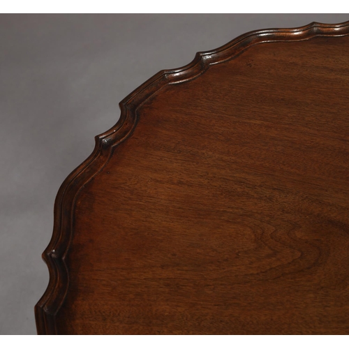 455 - A GEORGE III MAHOGANY TILT TOP TABLE, circular with pie crust rim on a writhern vase turned pedestal... 