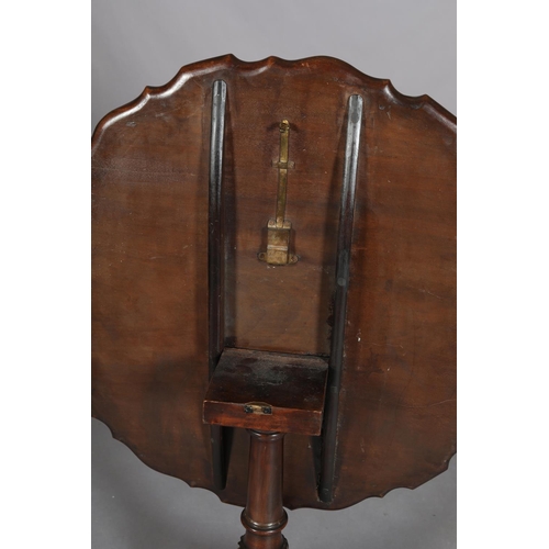 455 - A GEORGE III MAHOGANY TILT TOP TABLE, circular with pie crust rim on a writhern vase turned pedestal... 