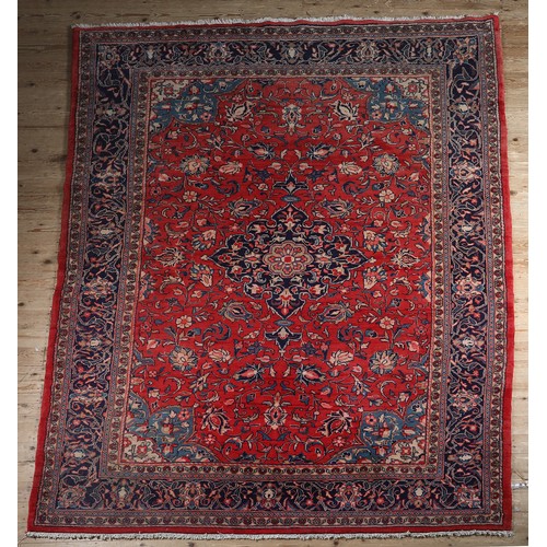 470 - A PERSIAN CARPET, the rose ground having a dark blue medallion, blue and ivory spandrels, all over p... 