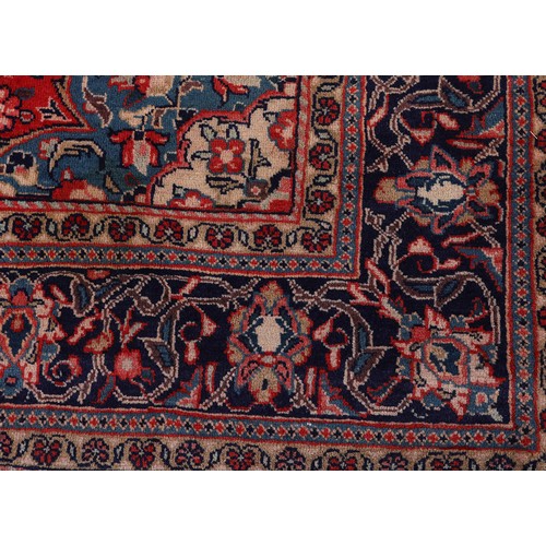 470 - A PERSIAN CARPET, the rose ground having a dark blue medallion, blue and ivory spandrels, all over p... 