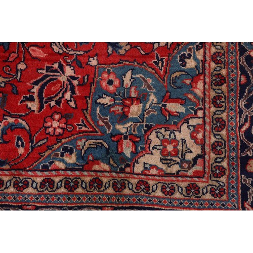 470 - A PERSIAN CARPET, the rose ground having a dark blue medallion, blue and ivory spandrels, all over p... 