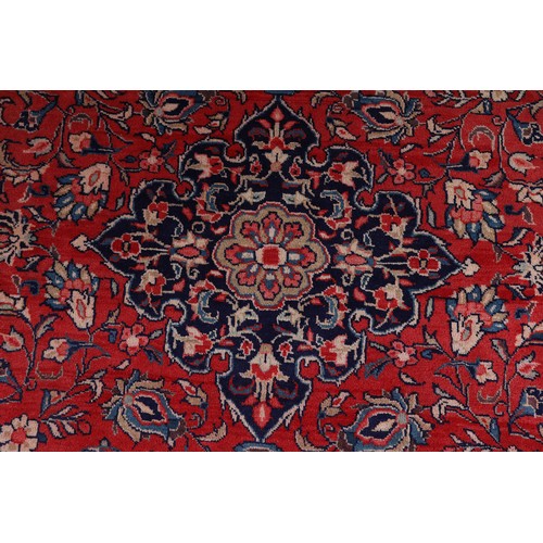 470 - A PERSIAN CARPET, the rose ground having a dark blue medallion, blue and ivory spandrels, all over p... 