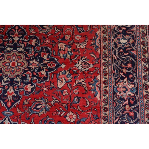 470 - A PERSIAN CARPET, the rose ground having a dark blue medallion, blue and ivory spandrels, all over p... 