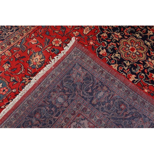 470 - A PERSIAN CARPET, the rose ground having a dark blue medallion, blue and ivory spandrels, all over p... 