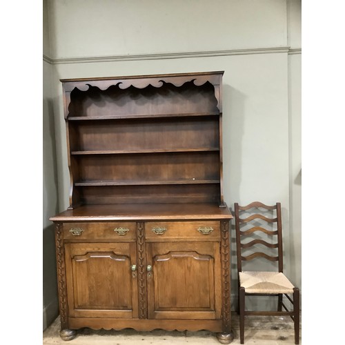 384 - A 1950s oak two door dresser with two drawers, turned bun feet, 120cm wide x 150cm high together wit... 