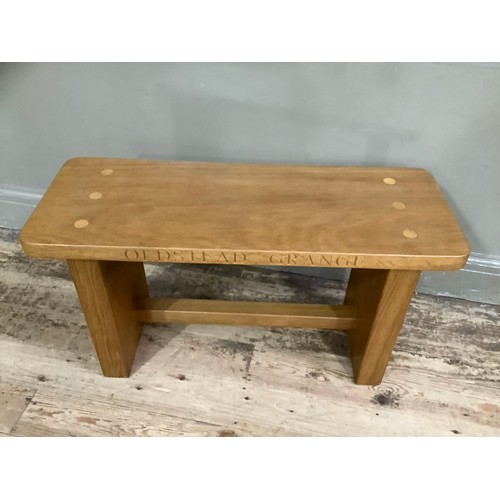 398 - A golden oak bench carved inscription 'Oldstead Grange', on twin supports and of rectangular outline... 