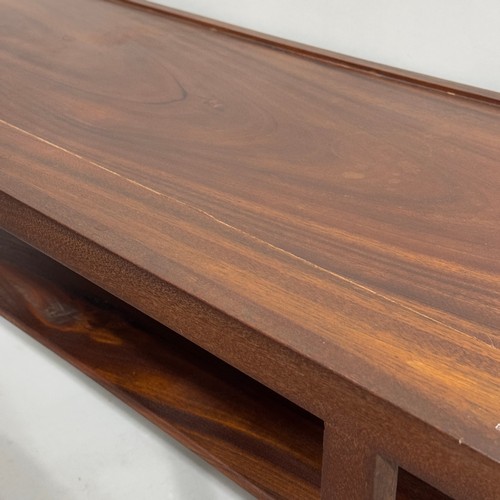 394 - A teak oblong coffee table with under tier in Indian rosewood, 100cm wide