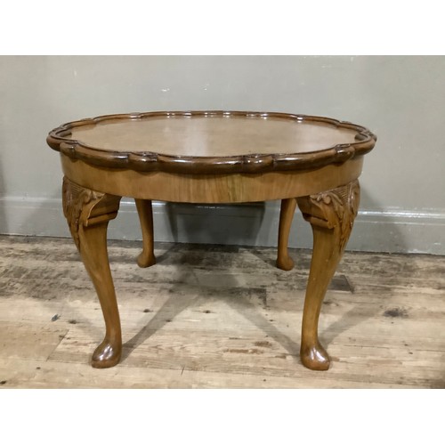 461 - A 1920s walnut occasional table with sunburst outline and on cabriole legs, 69cm wide