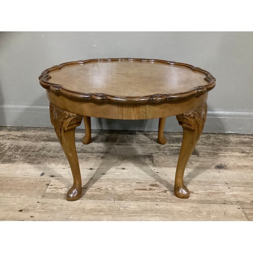 461 - A 1920s walnut occasional table with sunburst outline and on cabriole legs, 69cm wide