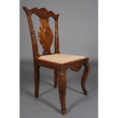 99 - A late 19th century Anglo Indian walnut sideboard and pair of single chairs, all-over carved in low ... 