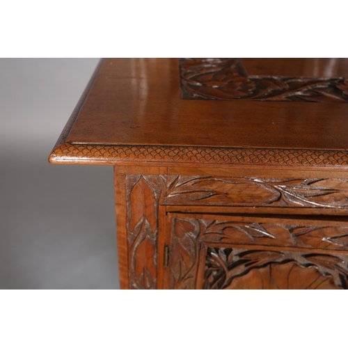 99 - A late 19th century Anglo Indian walnut sideboard and pair of single chairs, all-over carved in low ... 