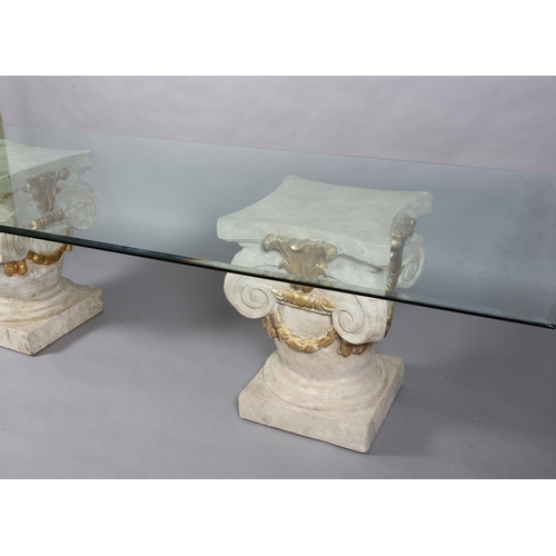 168 - A large glass dining table, rectangular, on two faux stone pedestals of urn and scroll design with g... 