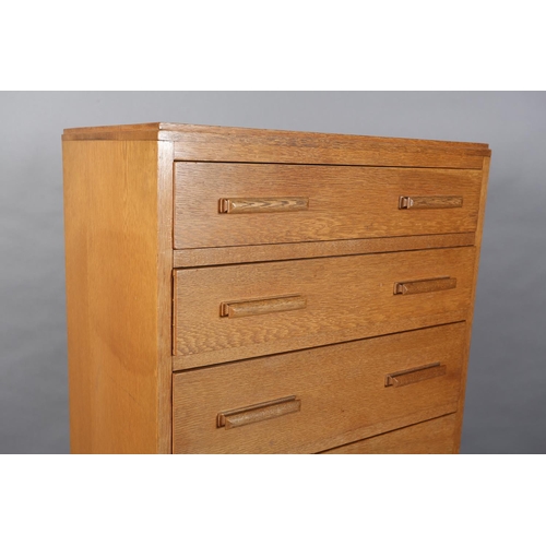 46 - A 1960's oak veneered chest of seven graduated drawers with bar handles, on plinth base, 61cm wide x... 