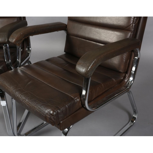 24 - Gordon Russell for Verco, c1970s, a pair of brown leather and chrome office desk chairs