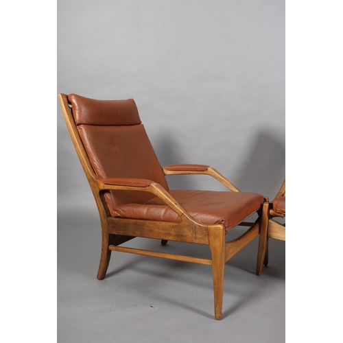 134 - A pair of polished beech and brown leather open armchairs on square tapered legs, c1970