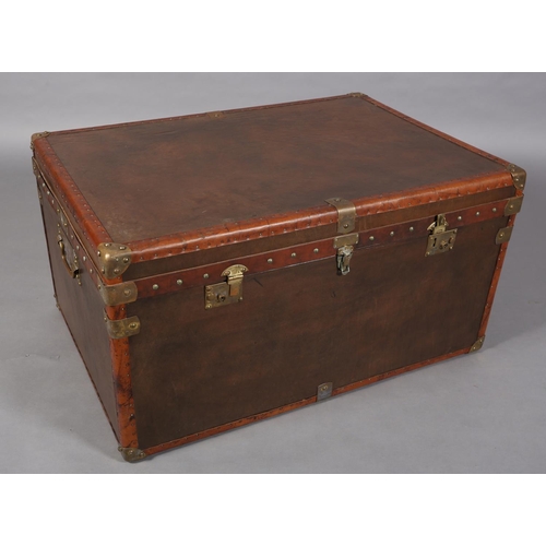 150 - A modern leather and brass studded trunk with brass mounts and side carrying handles, 95cm wide  x 6... 