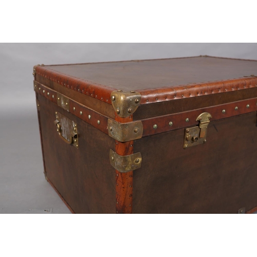 150 - A modern leather and brass studded trunk with brass mounts and side carrying handles, 95cm wide  x 6... 