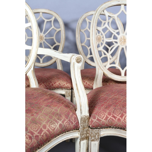 169 - A set of eight Regency style cream and gilt dining chairs with oval pierced backs and moulded frame,... 