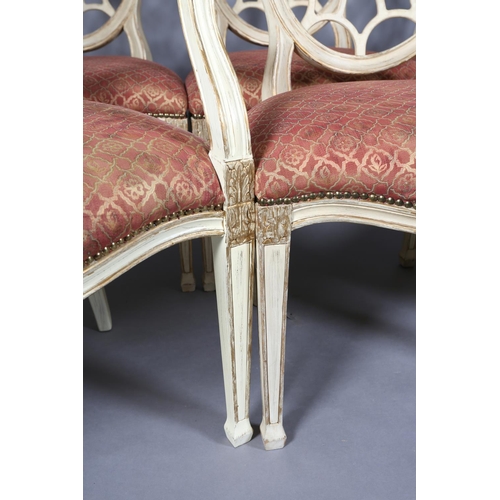 169 - A set of eight Regency style cream and gilt dining chairs with oval pierced backs and moulded frame,... 