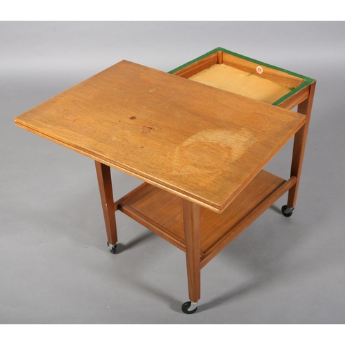 136 - A teak trolley by Eastcraft, Scotland, with rectangular fold over top, lined in baise and an underti... 