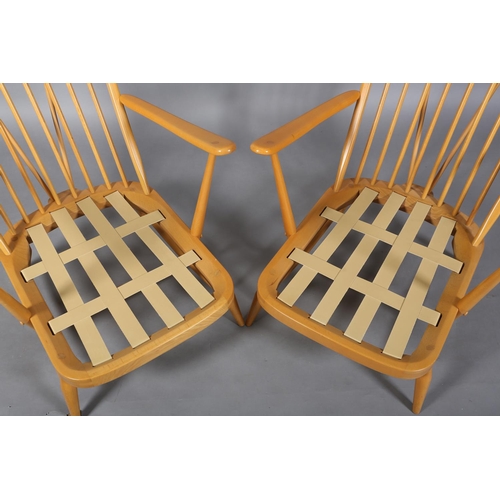 32 - A pair of Ercol Windsor beech armchairs, model 203 with loose back and seat cushions, (Please note: ... 