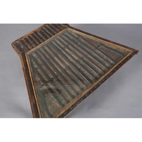 108 - A 19th century Indian bullock cart made into a coffee table, the ribbed surface with later glass sur... 