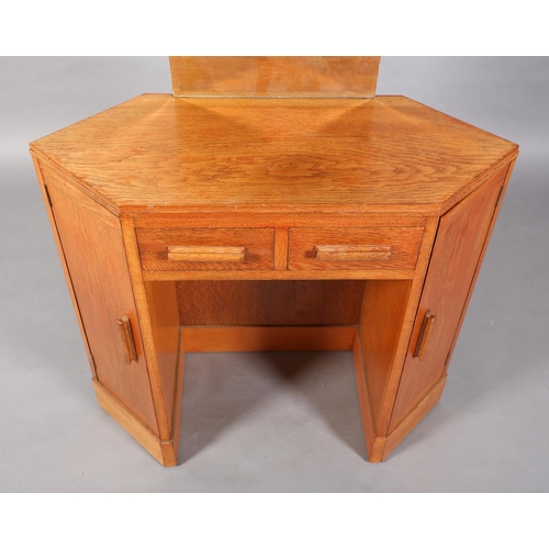 47 - A 1960s oak veneered dressing table, C.1960s of lozenge shape, having a bevelled mirror, two small d... 