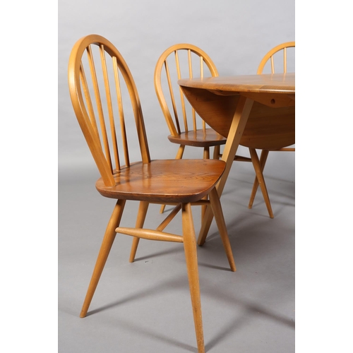 34 - An Ercol Windsor 400 beech and natural elm dining suite, oval drop leaf table and for hoop back chai... 