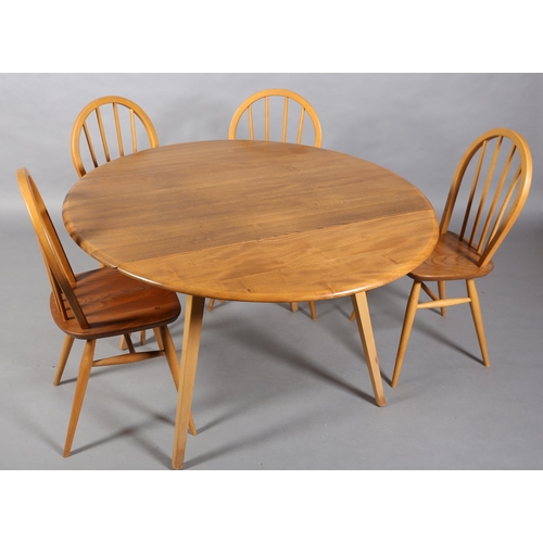 34 - An Ercol Windsor 400 beech and natural elm dining suite, oval drop leaf table and for hoop back chai... 