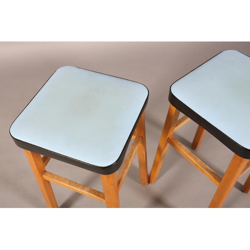 160 - A pair of English Maid beech stools, c1960s, with blue and black leather effect seats, 62cm high