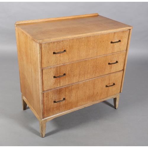 161 - A Lebus pale oak veneered chest of three graduated drawers with metal bar handles on slender bracket... 