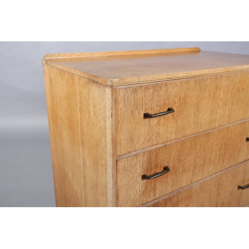 161 - A Lebus pale oak veneered chest of three graduated drawers with metal bar handles on slender bracket... 