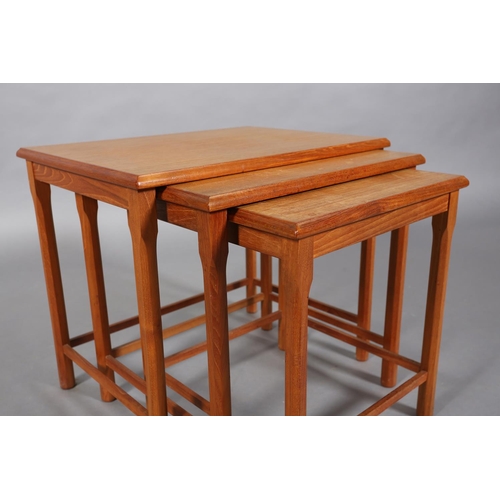 74 - A nest of three teak occasional tables, rectangular on chamfered legs, c1970s, 55cm wide x 47cm deep... 