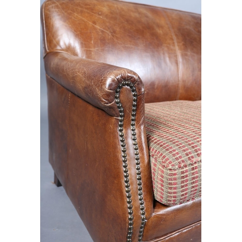 57 - A brown leather close-nailed two seater sofa in the 1920s style, having two cushion seat with interc... 