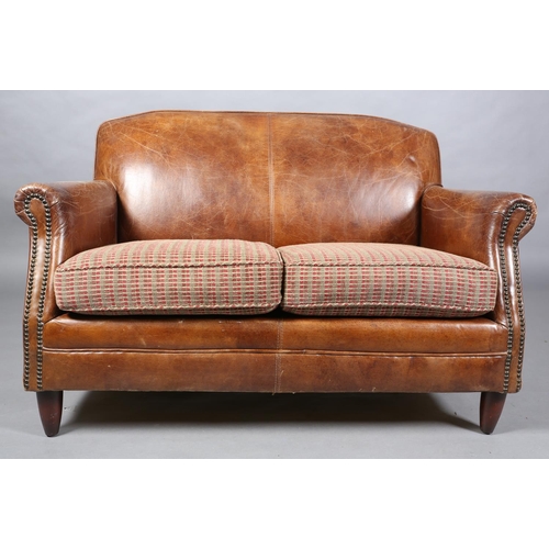 57 - A brown leather close-nailed two seater sofa in the 1920s style, having two cushion seat with interc... 