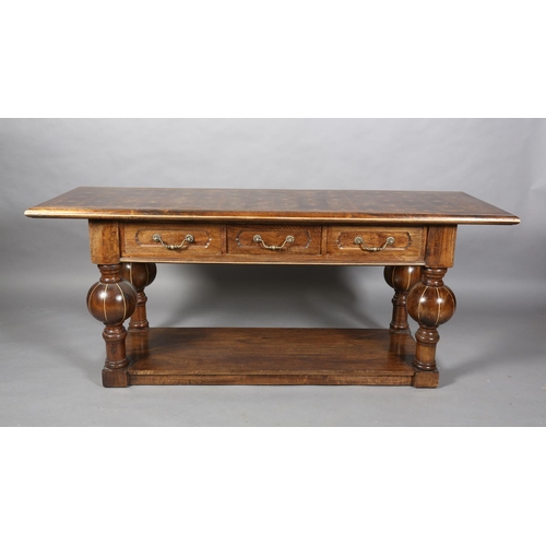 131 - An Italian hardwood hall or serving table, rectangular, having three drawers to the apron with brass... 